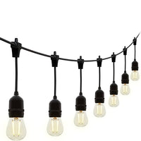 String of light bulbs hanging from a black cord against a white background