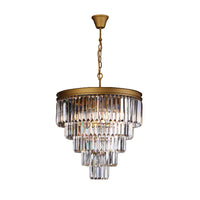 Chandelier with clear crystal tiers and gold accents on a black background