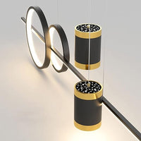 Modern wall-mounted light fixture with cylindrical design and gold accents on a neutral background